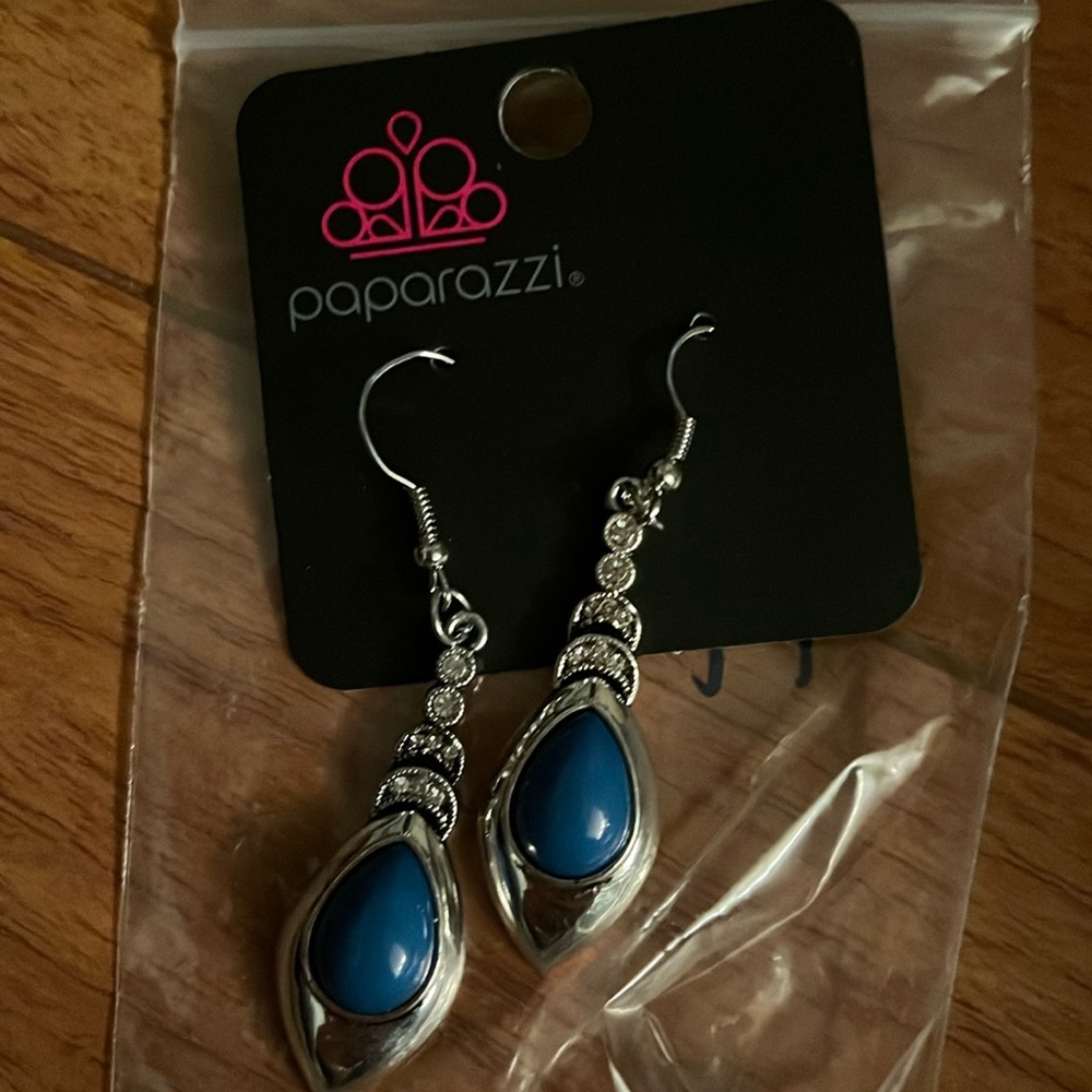 Silver and blue earrings with tags